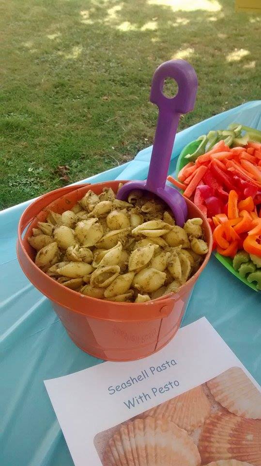 Sea shell pasta served in a bucket with a spade 